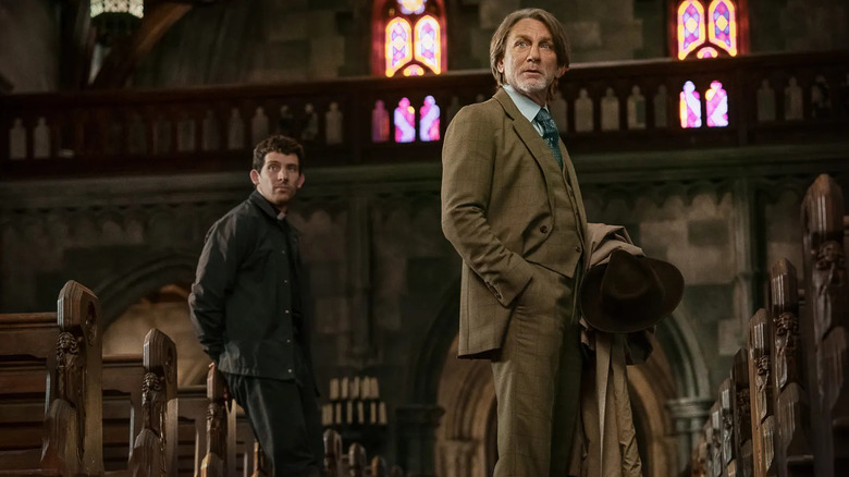 Jud and Blanc in the church looking over at someone in Wake Up Dead Man