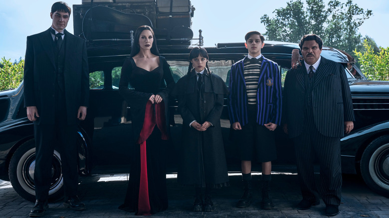 The Addams family lined up outside their car on 