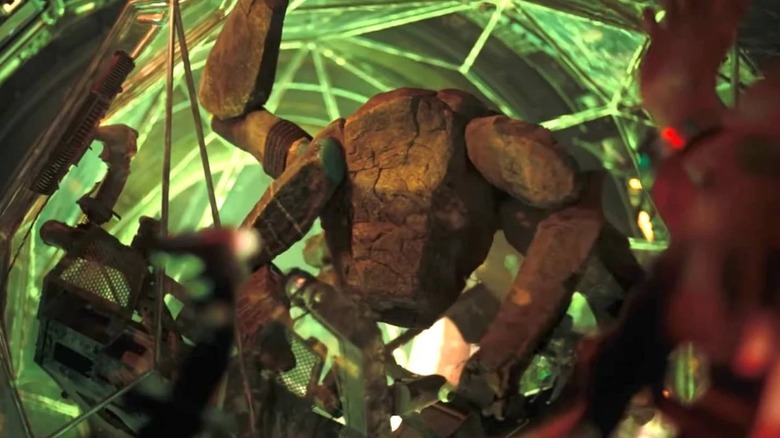 Rocky in his ship with green light behind him in 