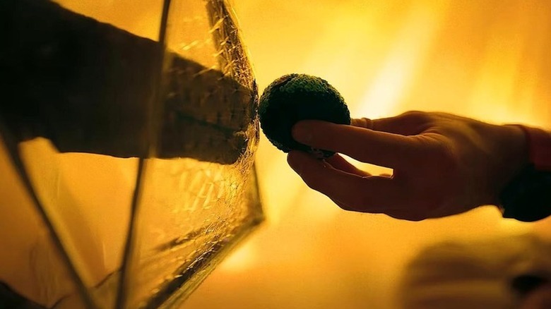 Grace handing Rocky a model of Earth in "Project Hail Mary" (2026)