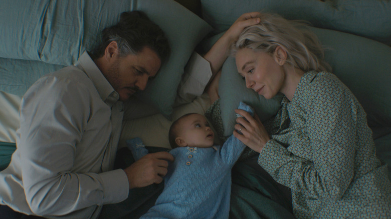 Reed and Sue rest on bed with Franklin in 