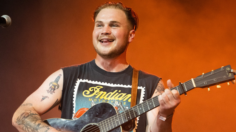 Zach Bryan playing guitar