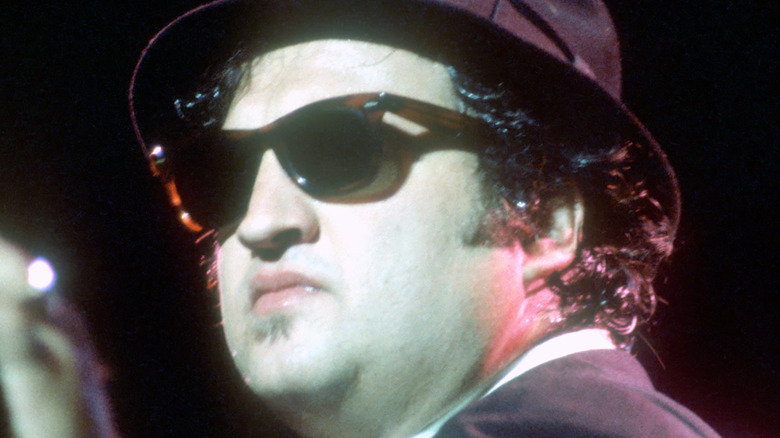 John Belushi wearing glasses