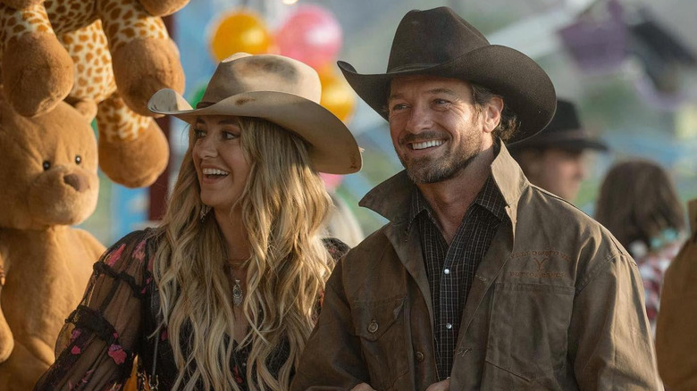 Ryan and Abby at a country fair smiling in "Yellowstone"