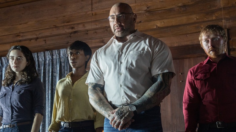 Two women and two men stand in a line-up inside a cabin