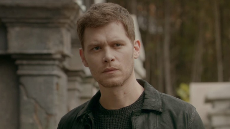 Klaus stands in cemetery 
