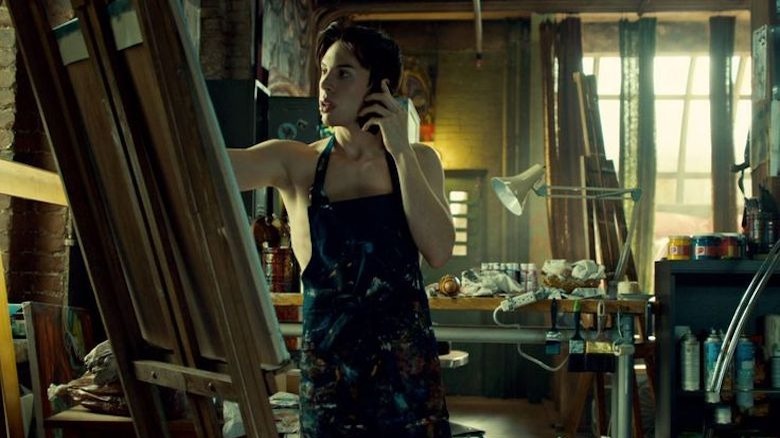 Felix painting in an apron 