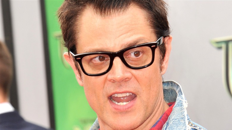 Johnny Knoxville wearing black frame glasses