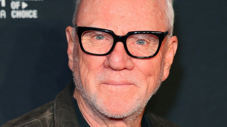 Malcolm McDowell smiling at a movie premiere