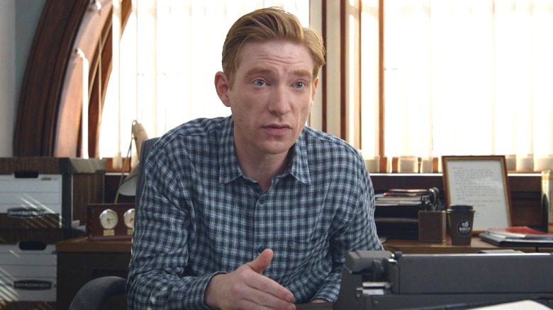Ned sitting at his desk while being interviewed by the documentary crew