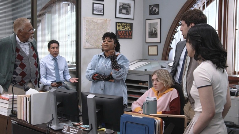 The majority of the Truth Teller staff discussing Ken's fixation on their work habits