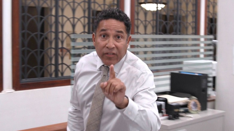 Oscar pointing and raising his voice to the documentary crew
