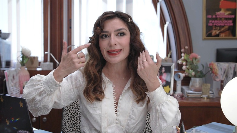 Esmeralda talking to the documentary crew in her cluttered office