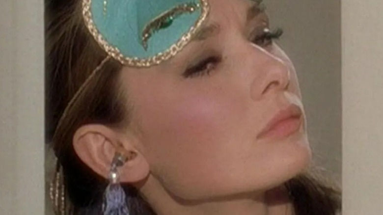 Holly Golightly wearing earplugs