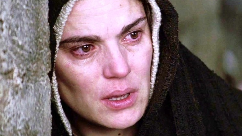 Mary watches as Jesus continues with the cross