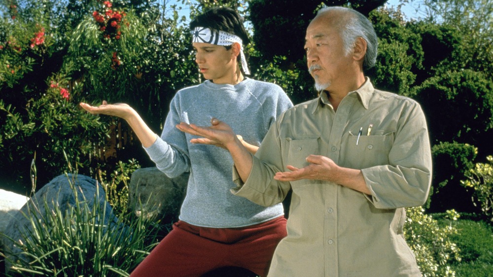 Daniel Larusso and Mr. Miyagi do karate in The Karate Kid