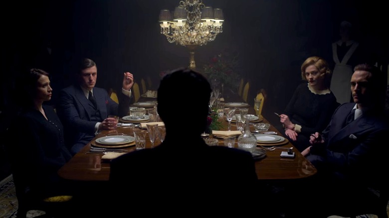 Characters from Peaky Blinders sitting at a dinner table