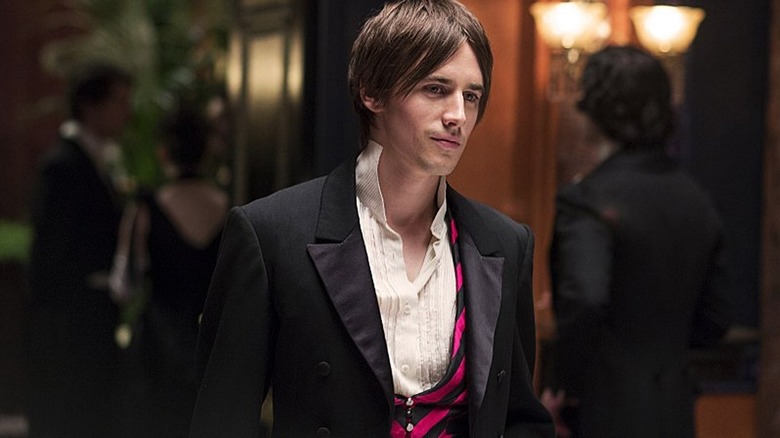 Dorian in suit standing at party