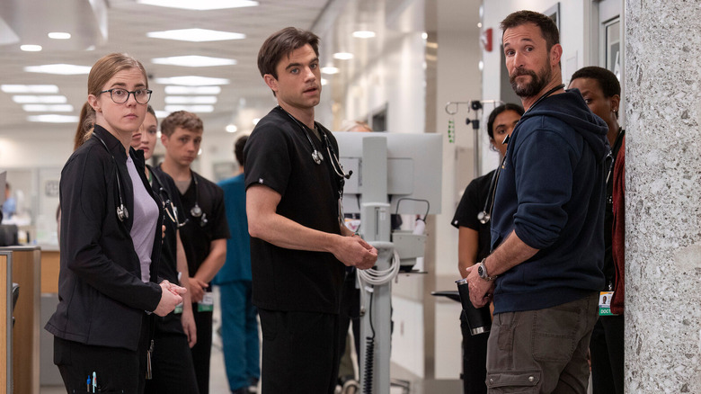 Dr. Robby talking with staff members in The Pitt