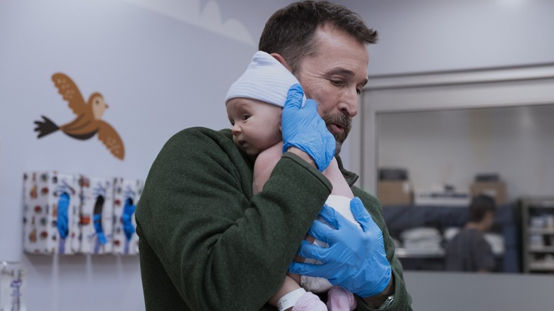 Robby holding a baby on The Pitt season 2