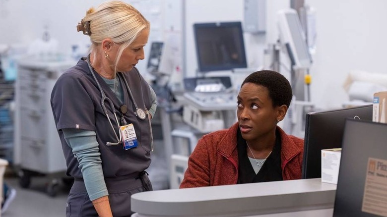 Dana and Heather at the nurse's station talking on The Pitt