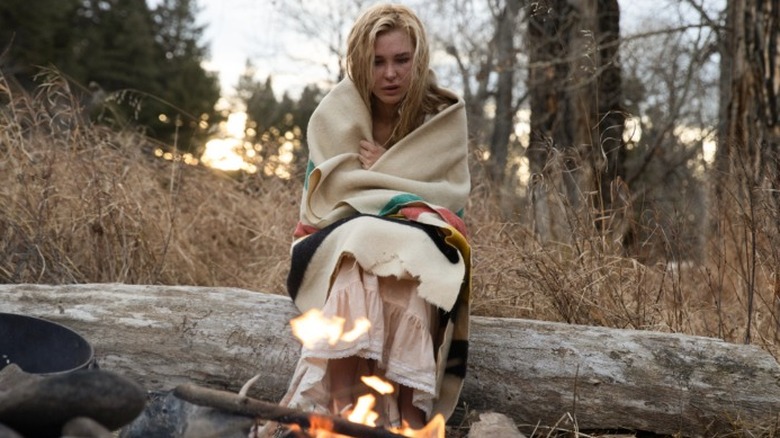 Elsa Dutton sitting by a fire with a Point Blanket