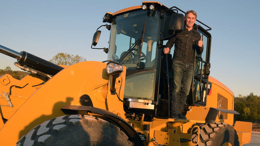 Mike Wolfe standing tractor