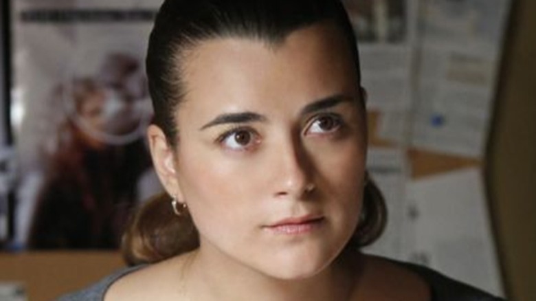 Ziva in front of a bulletin board