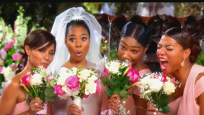 A bridal party holding flowers