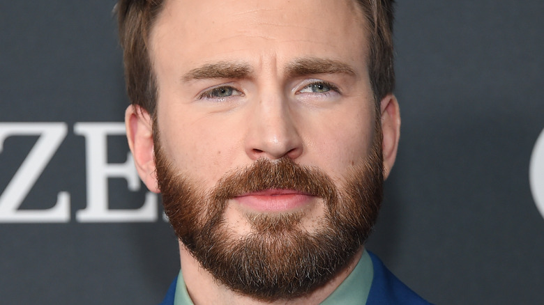 Chris Evans stops to get his picture taken at a premier