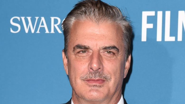 Chris Noth smiling on red carpet