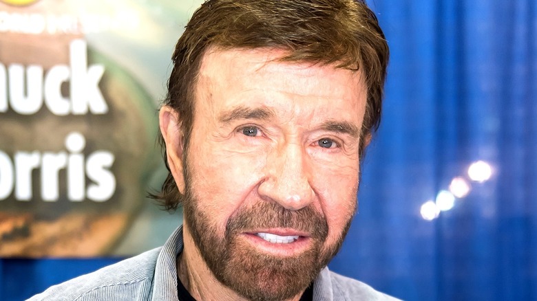 Chuck Norris smiling at booth