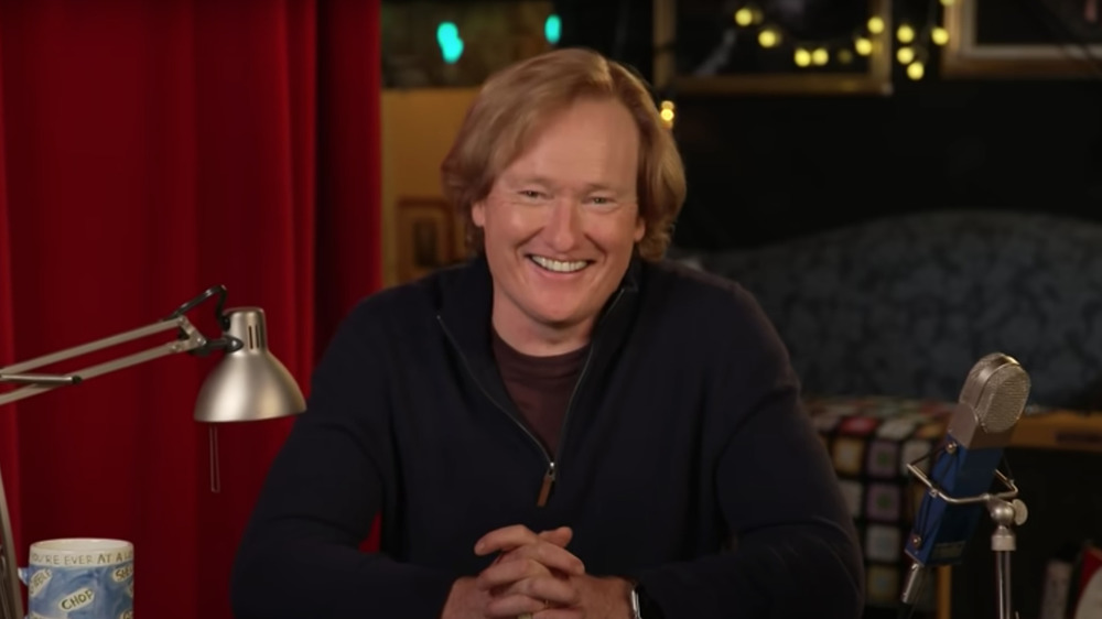 Conan O'Brien smiling and hosting Conan on TBS 
