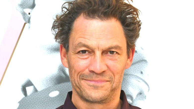 Dominic West smiling with white background