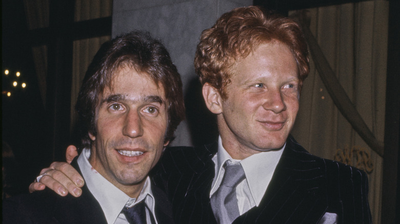 Don Most with his arm around Henry Winkler's shoulder
