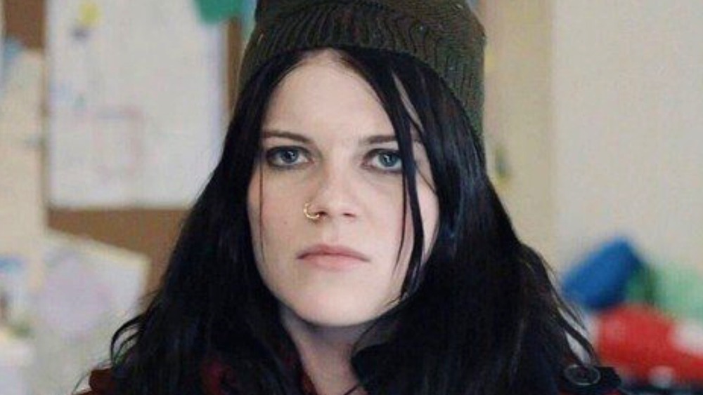 Mandy Milkovich grimacing wearing hat