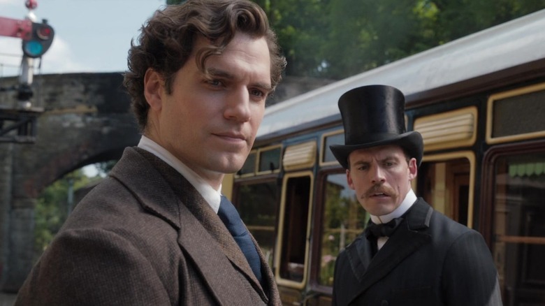 Sherlock and Mycroft next to train
