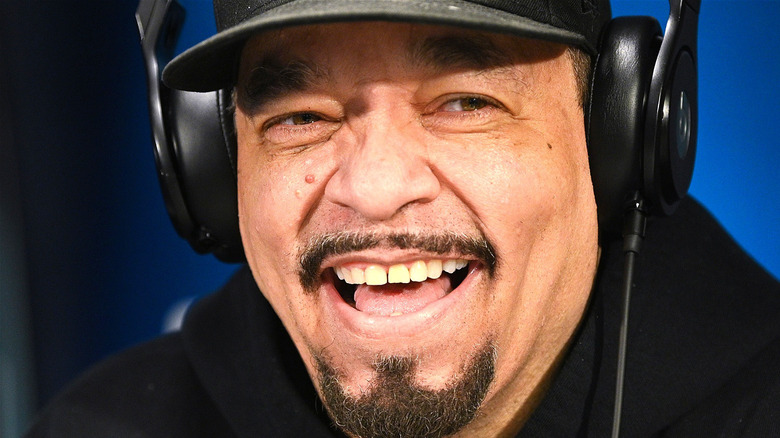 Ice T smiles and looks to his left