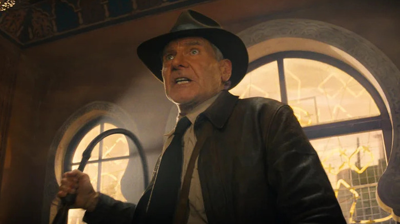 Indiana Jones holding a whip in Indiana Jones and the Dial of Destiny
