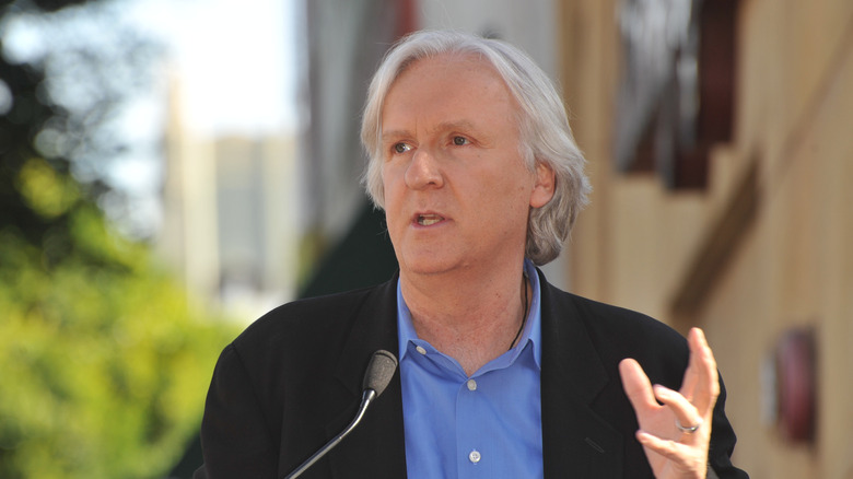 James Cameron wearing blue shirt