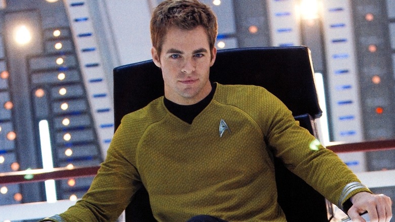 Young Kirk sitting in his captain's chair on Star Trek (2009)