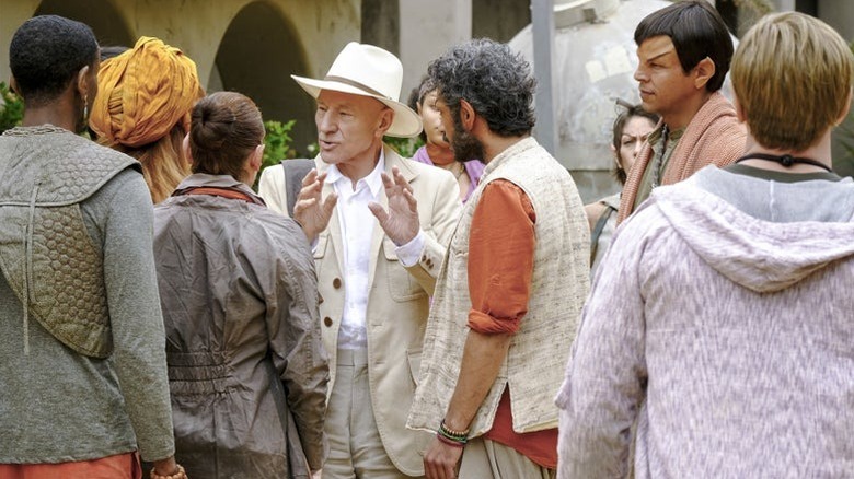 Picard surrounded by Romulan civilians in Star Trek: Picard