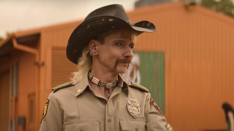 John Cameron Mitchell as Joe Exotic smirking