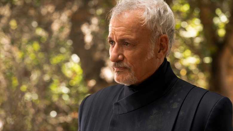 An older Q returns in a black suit for Star Trek: Picard