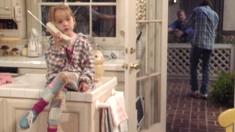 Morgan Matthews sitting on kitchen counter