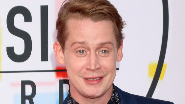 Macaulay Culkin smiling for press