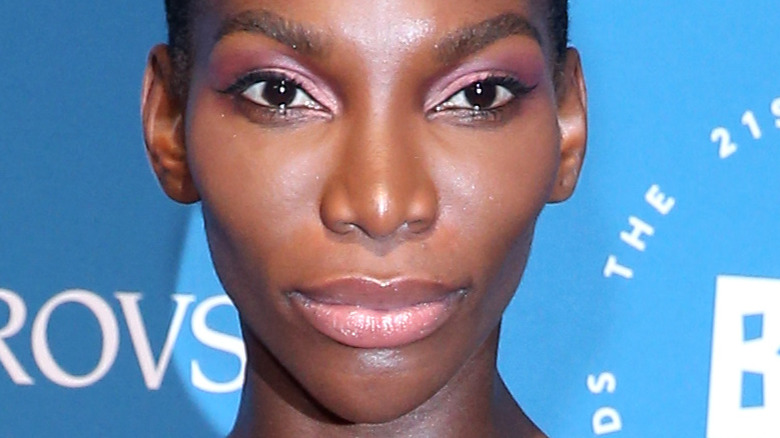 Michaela Coel smirking at an event