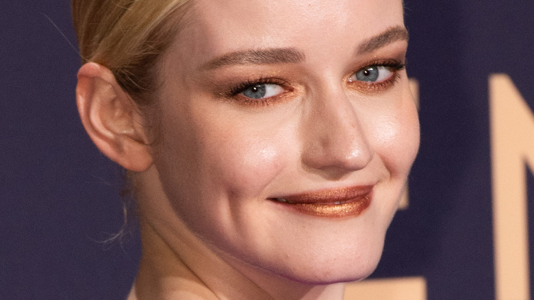 Julia Garner holding her Emmy