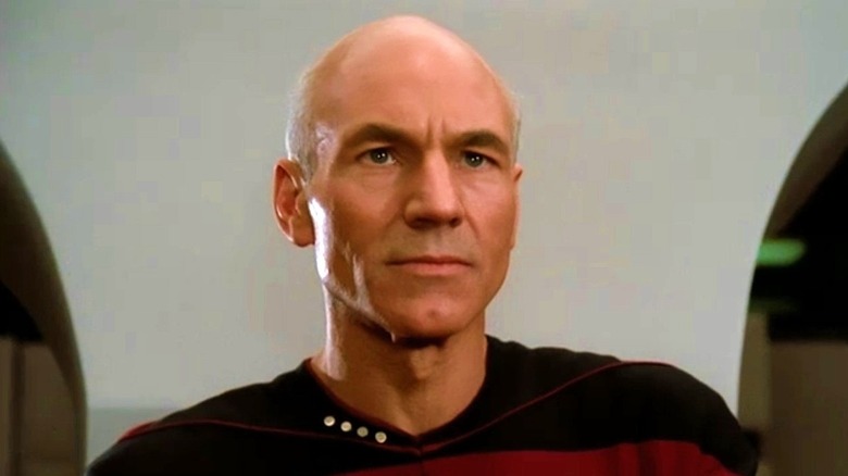 Picard stands in front of a wall