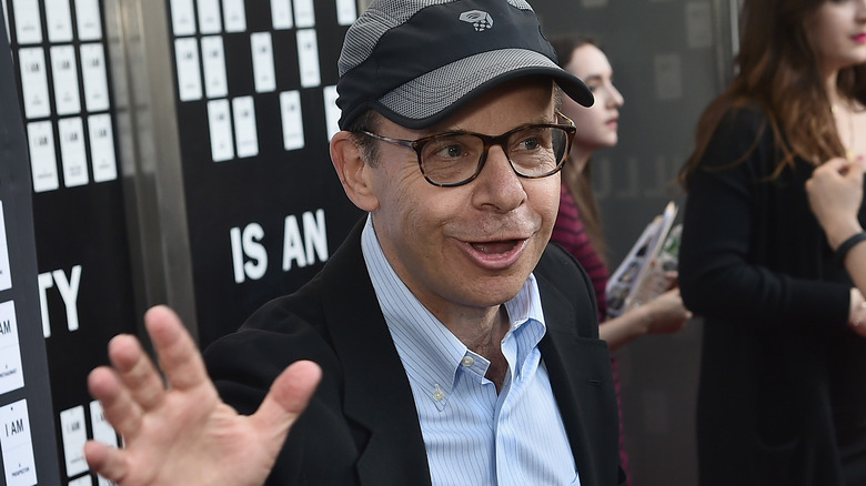 Rick Moranis waving hand at public event